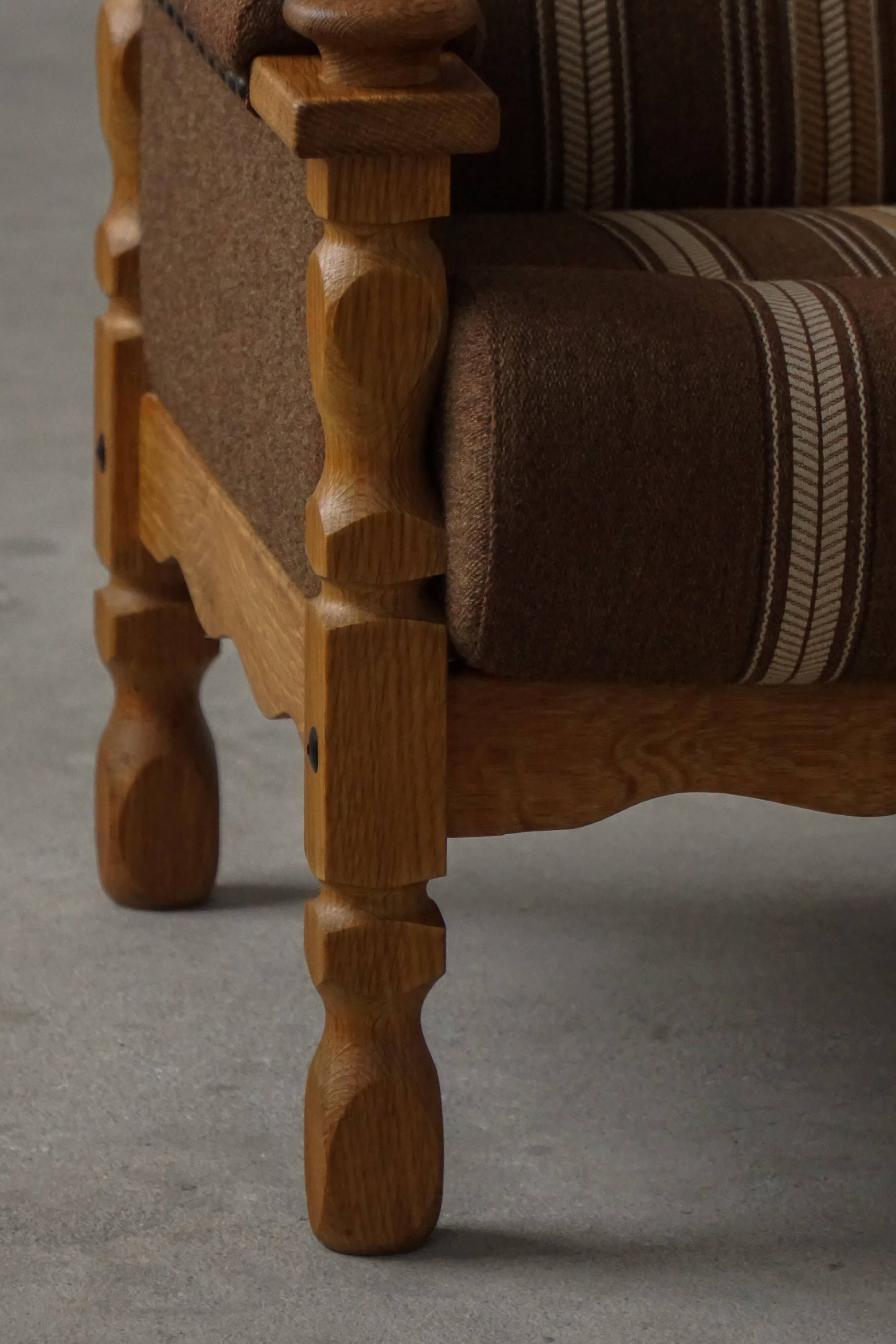 Modern Danish, a pair of lounge chairs in oak and wool, Henning Kjærnulf, 1960s.