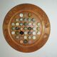 Ancient solitaire game in wood and stone marbles