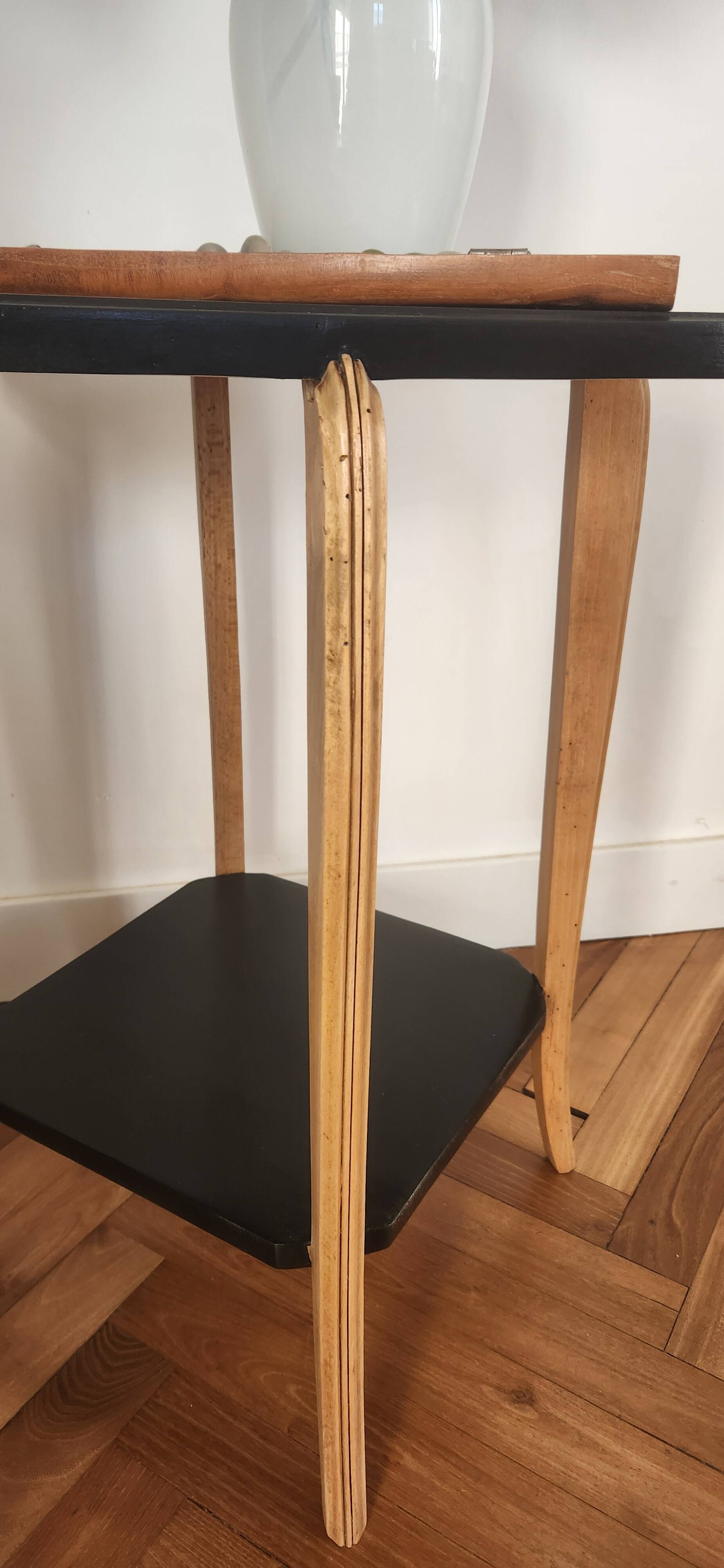 Black lacquered wooden side table with offset tops.