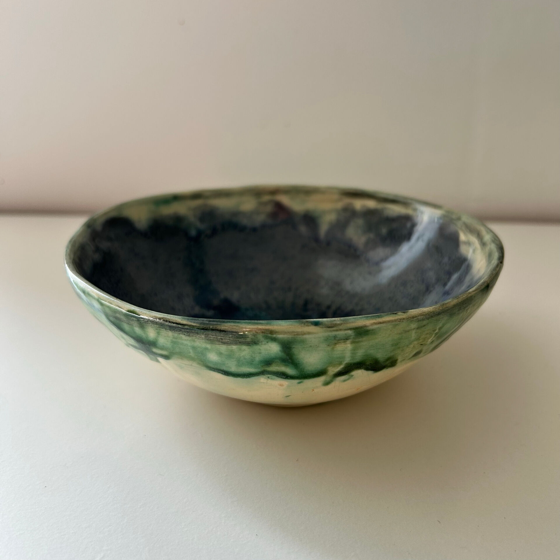 Green bowl signed with an eye