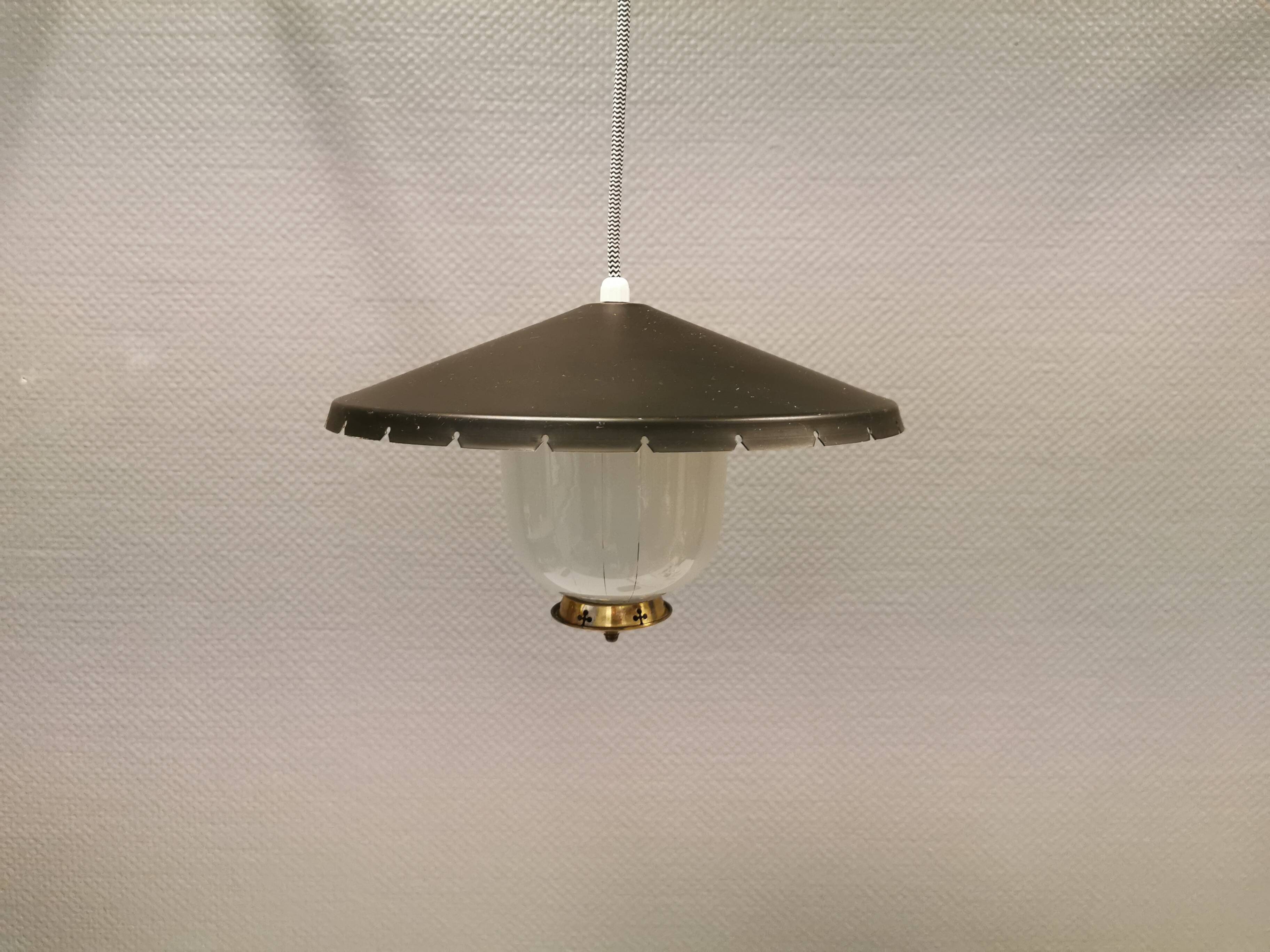 Hanging lamp in glass with black lacquered metal shade and brass base.