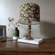 brass table lamp | khaki lampshade with multicoloured daisies