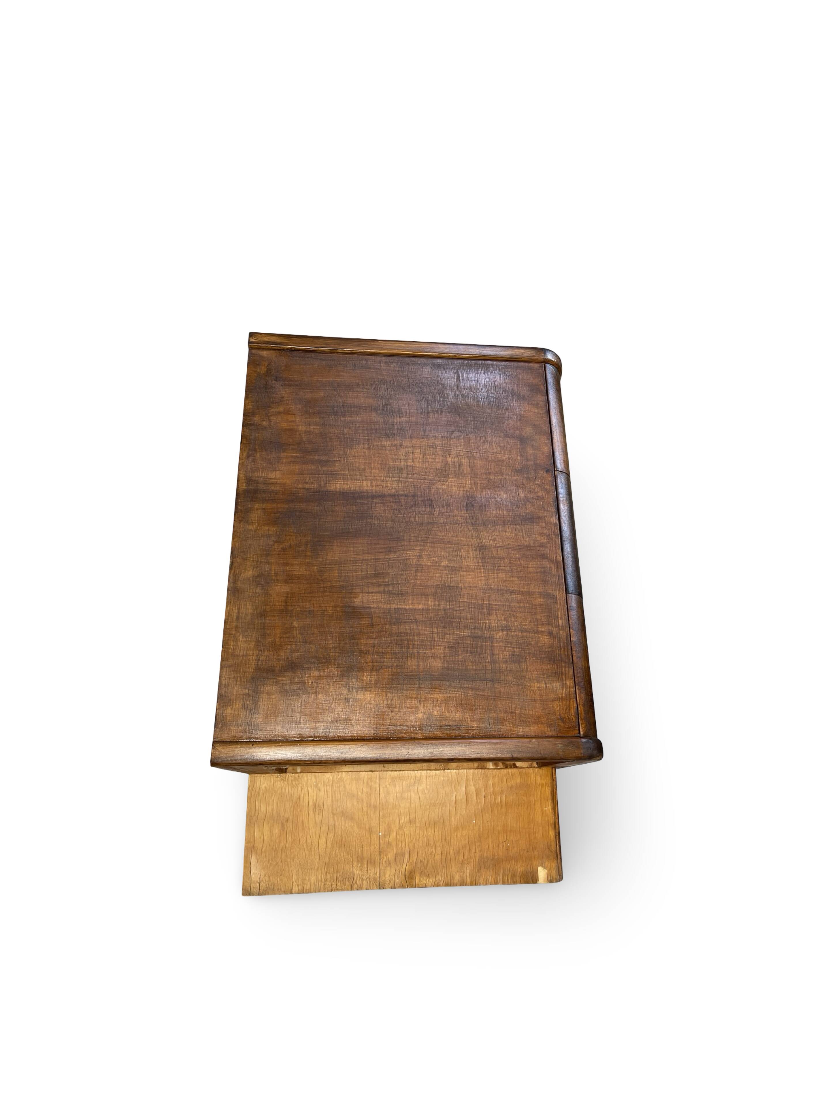 A vintage Italian chest of drawers, made of veneered walnut and solid wood,