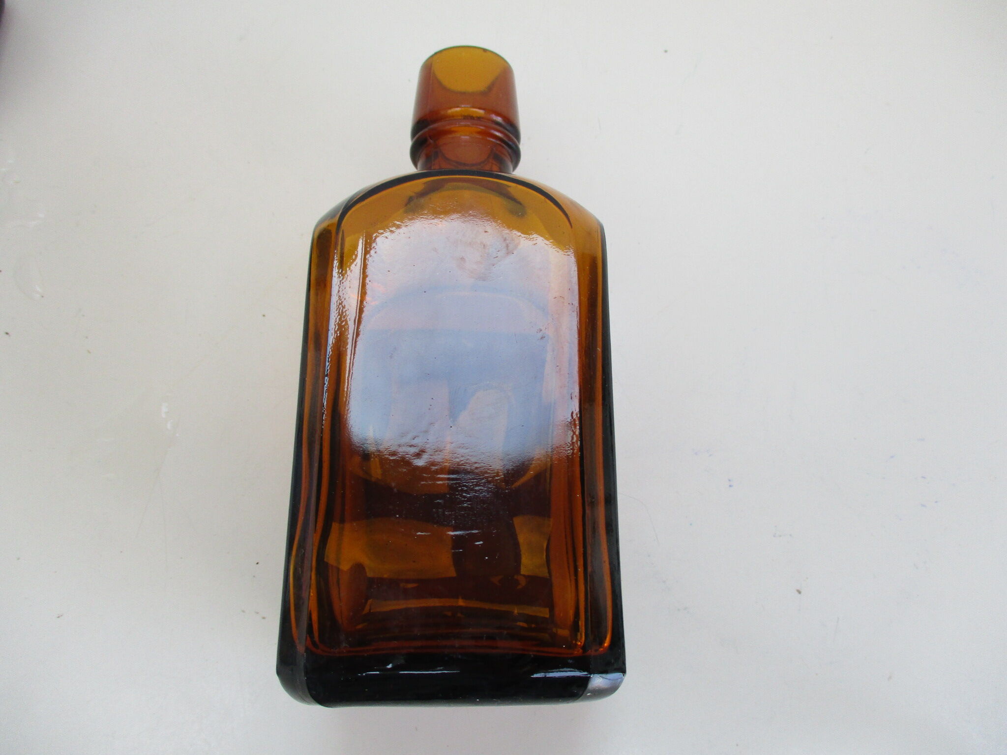 2 amber glass bottles with their old labels