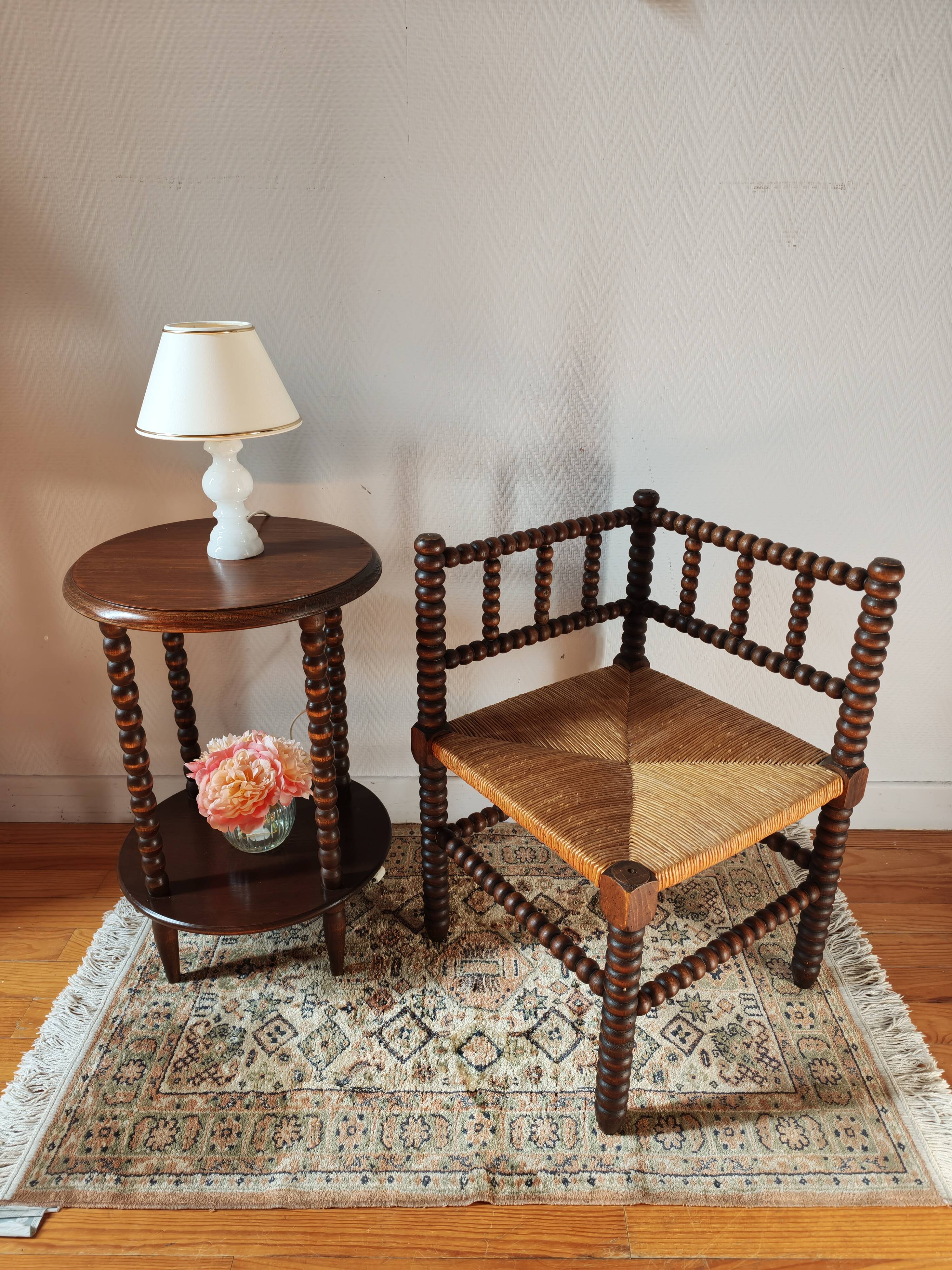 Old wooden turned spindle fireside chair with a straw seat.