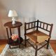 Old wooden turned spindle fireside chair with a straw seat.