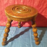Wooden milking stool with twisted legs