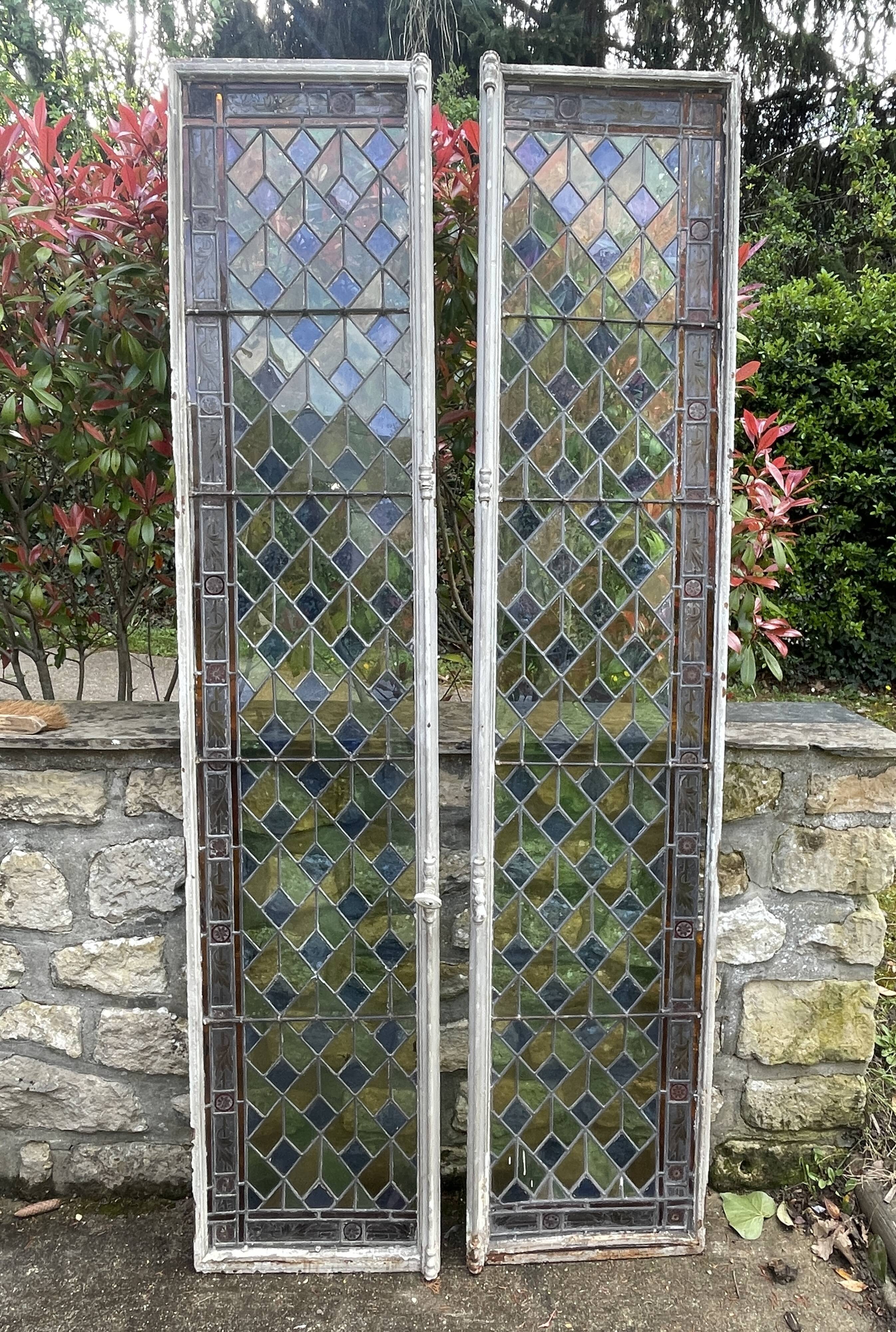 Pair of old double stained glass doors. Metal frames. Stained glass windows