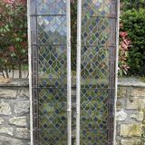 Pair of old double stained glass doors. Metal frames. Stained glass windows