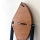 Modernist round folding dining table in wood and metal.