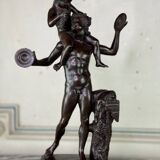 Dionysus on the shoulders of a satyr, bronze after the antique on a yellow Siena base.