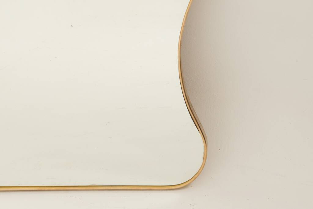 Golden brass mirror in the style of Gio Ponti and the 1980s.