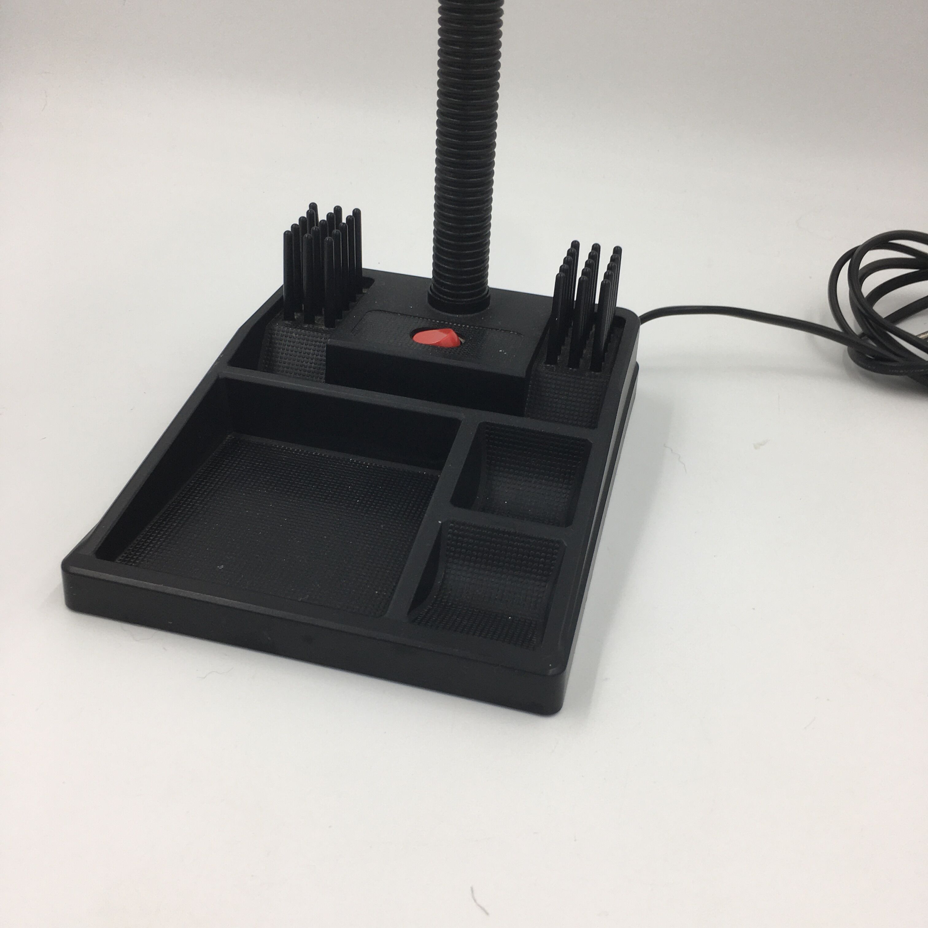 Duo of red and black flexible desk lamps with pencil holder