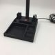 Duo of red and black flexible desk lamps with pencil holder