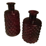 2 red molded glass bottles or jars
