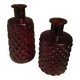 2 red molded glass bottles or jars