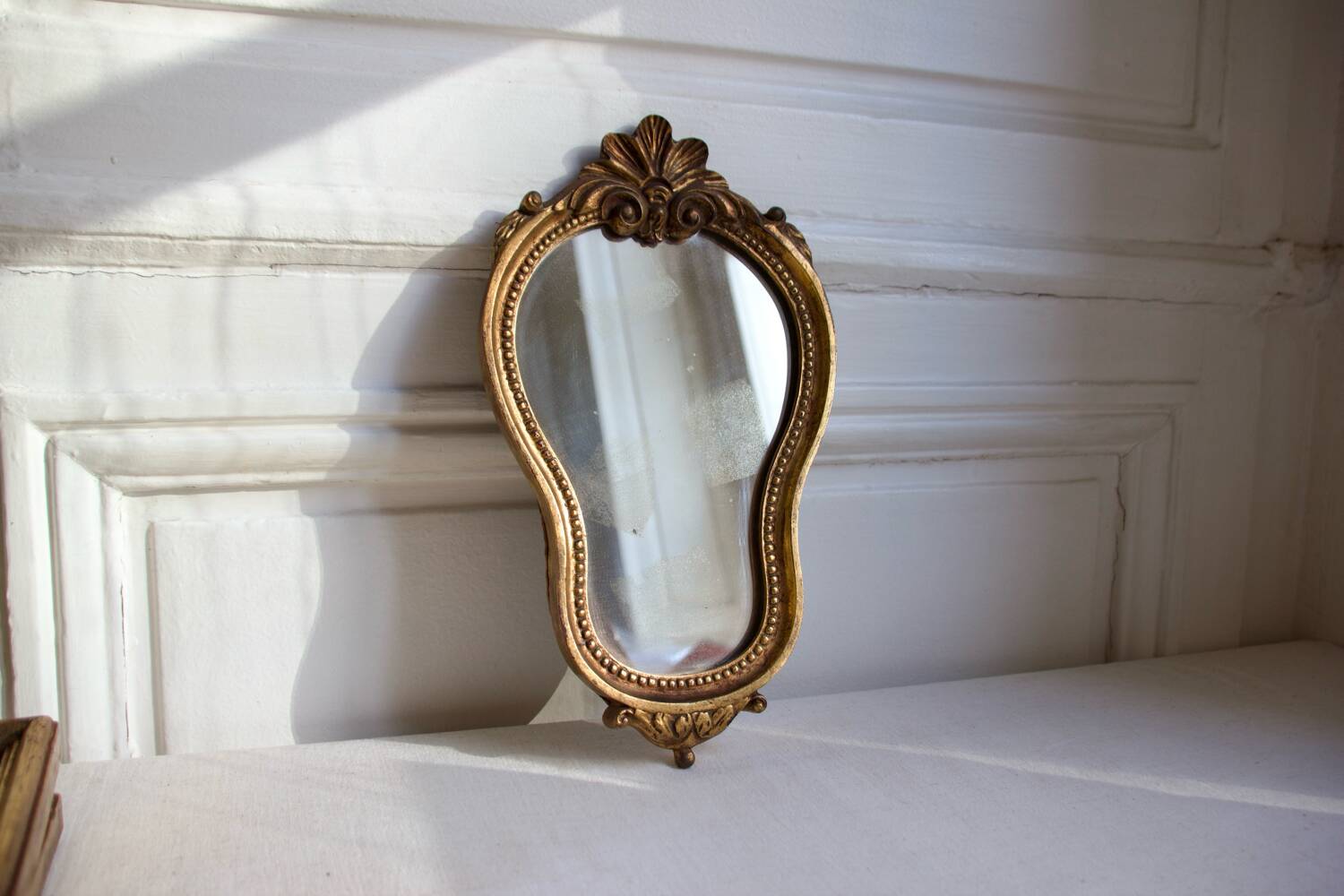 Small golden mirror in baroque style