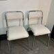 Pair of chrome chairs upholstered in boucle fabric.