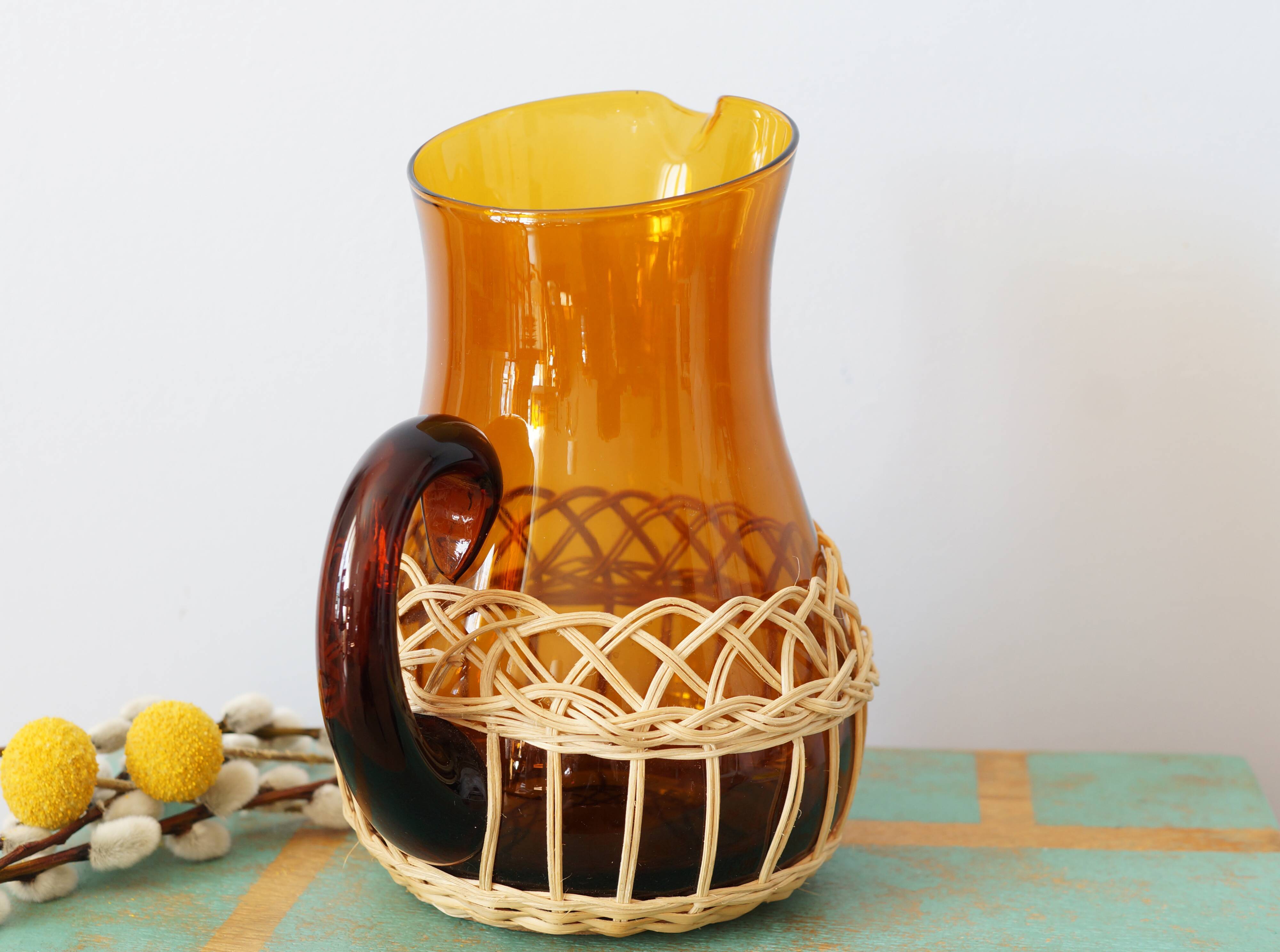 Amber glass decanter dressed in wicker, vintage