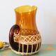 Amber glass decanter dressed in wicker, vintage