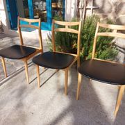 3 Scandinavian style chairs, light wood and black faux leather.
