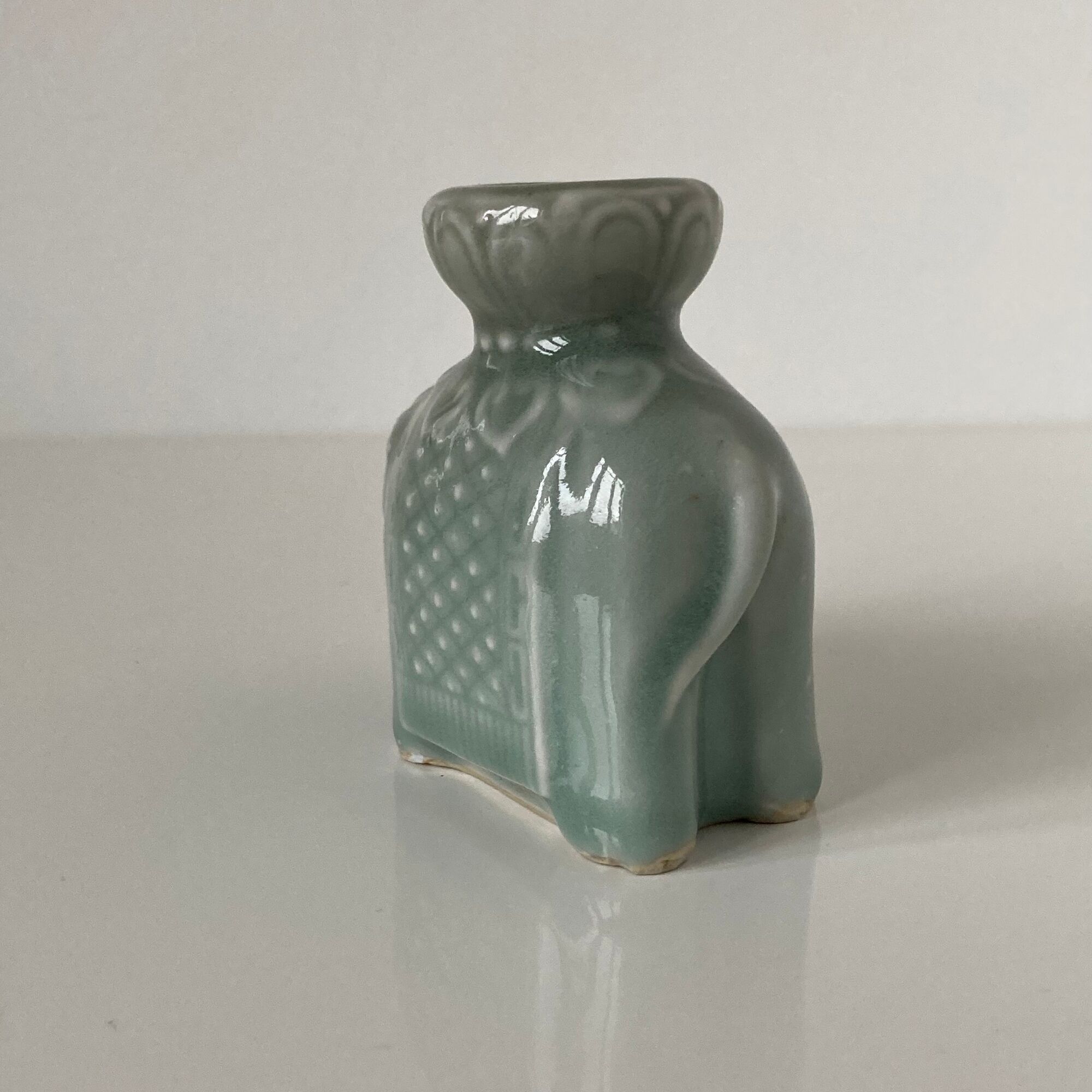 Porcelain candle holder and celadon cover in the shape of an elephant