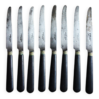 A set of 8 small knives with black wooden ferrules