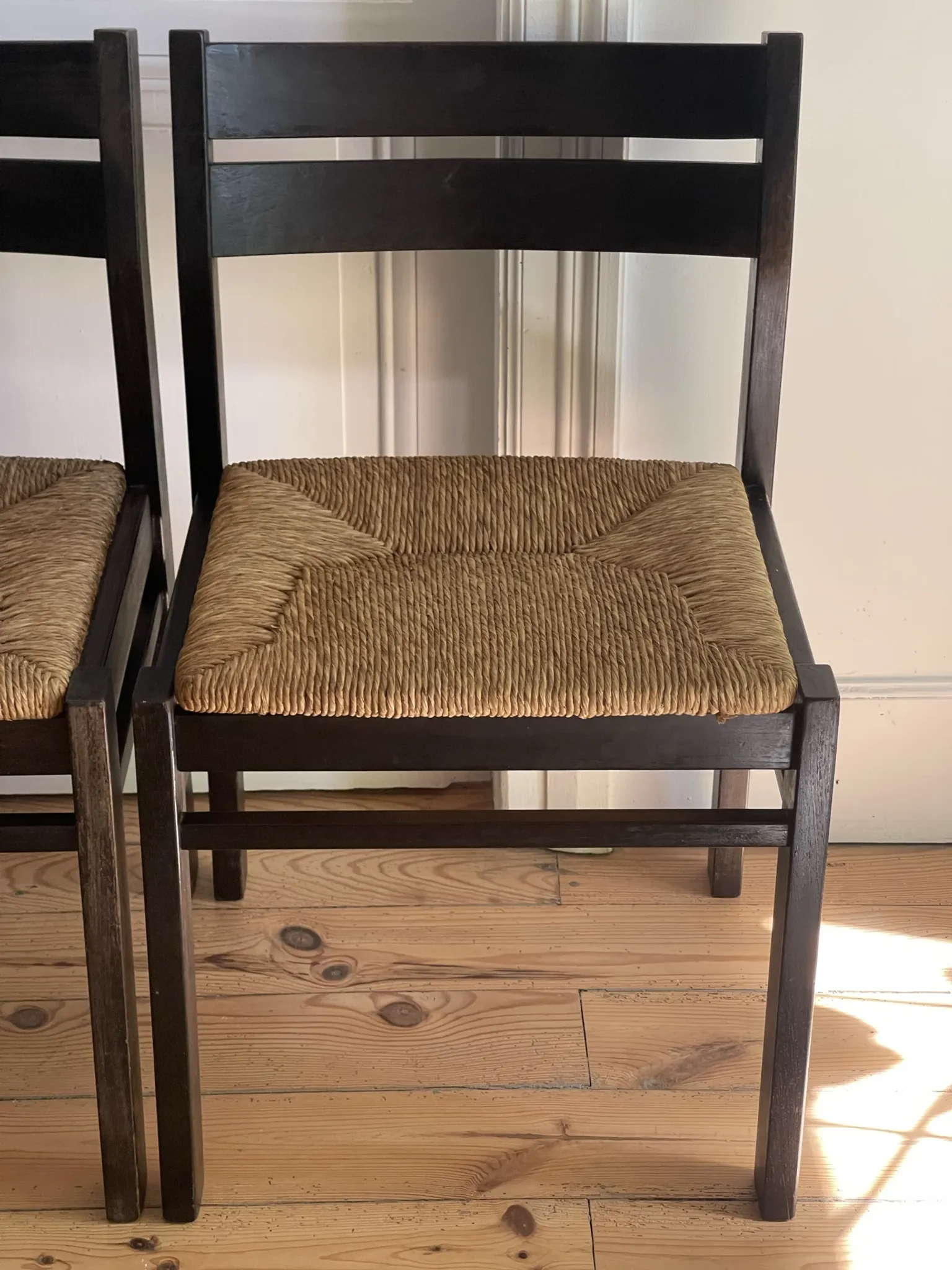 Pair of straw-seated wooden chairs in the regain style.