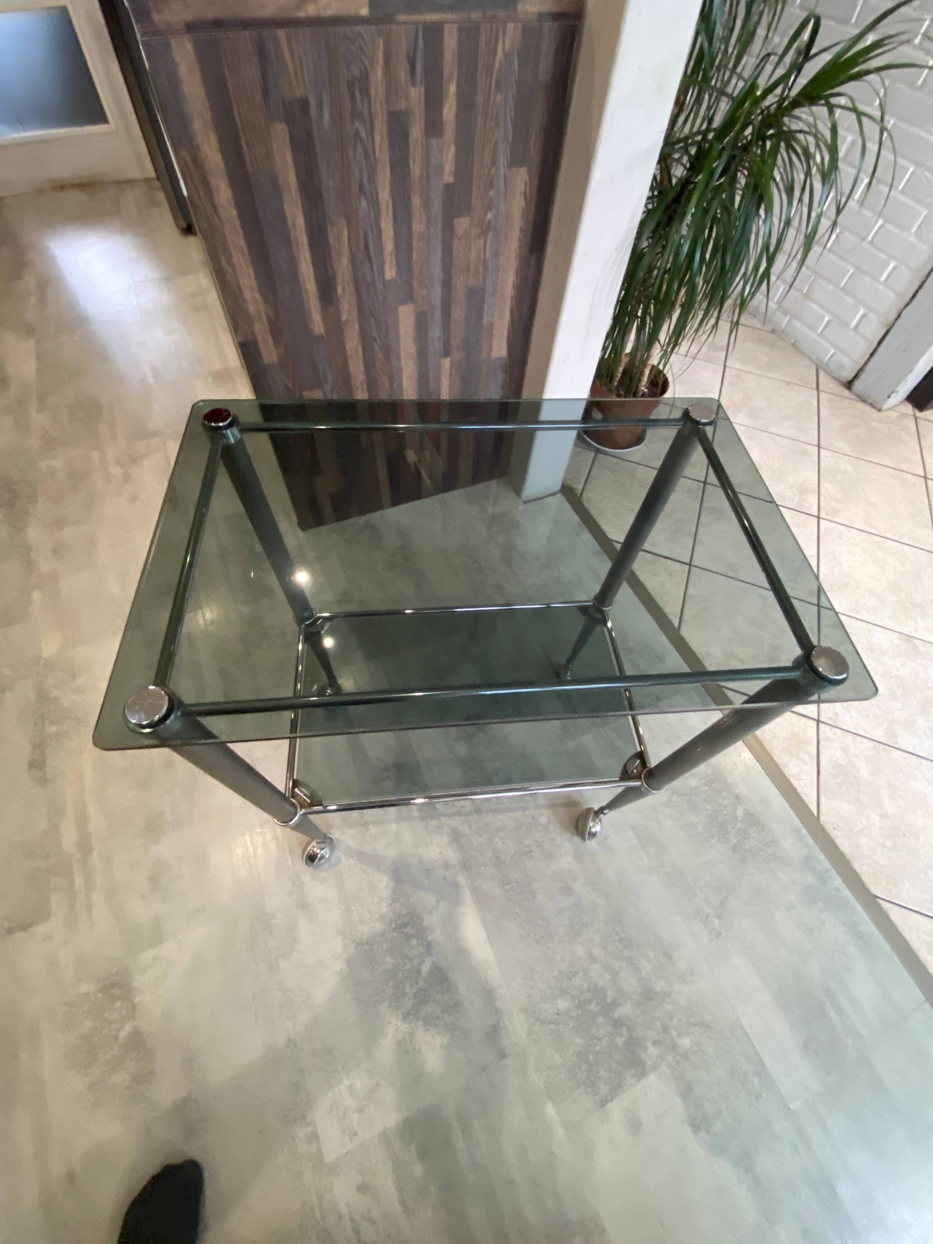 Serving dessert trolley with 2 smoked glass shelves and metal structure.