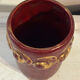 Mid-century relief vase in ruby red enhanced with gilding.