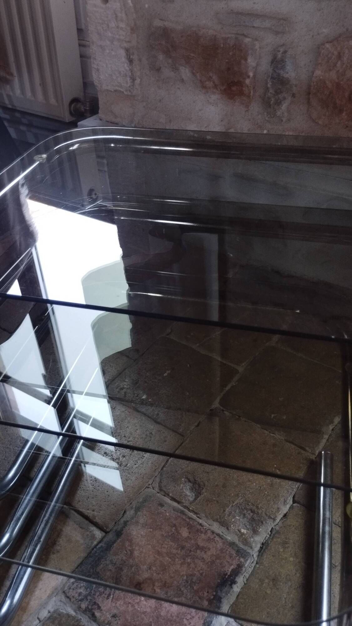 Nest of tables in glass and chrome steel.