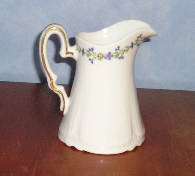 Pitcher in Limoges porcelain, barbel decoration