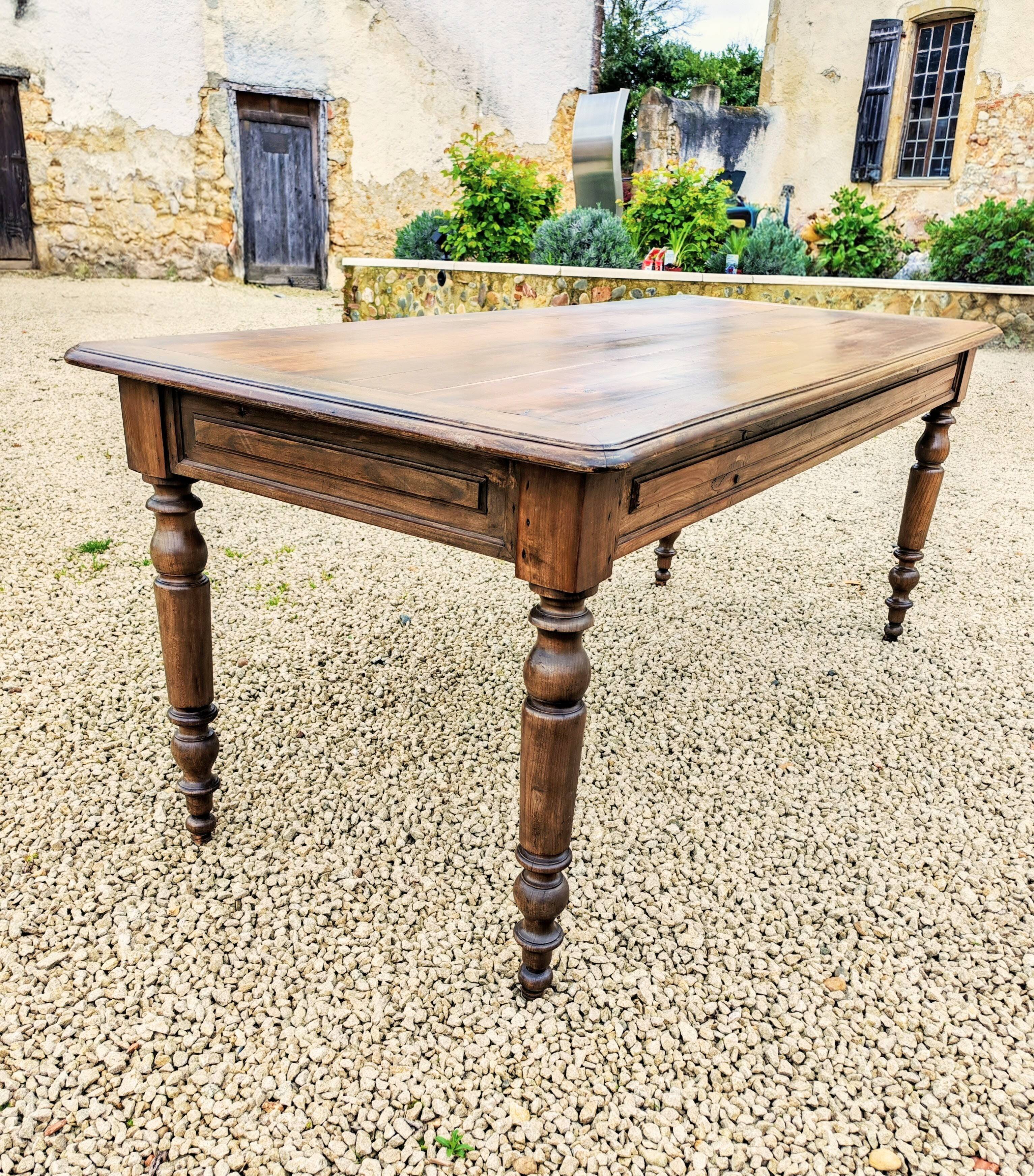 Old French farmhouse table in walnut with turned legs.