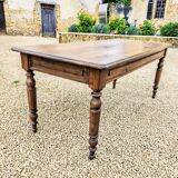 Old French farmhouse table in walnut with turned legs.
