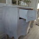 Curved patinated chest of drawers pearl grey waxed finish