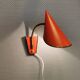 Danish red lacquered wall light with brass details. Estimated 1980s
