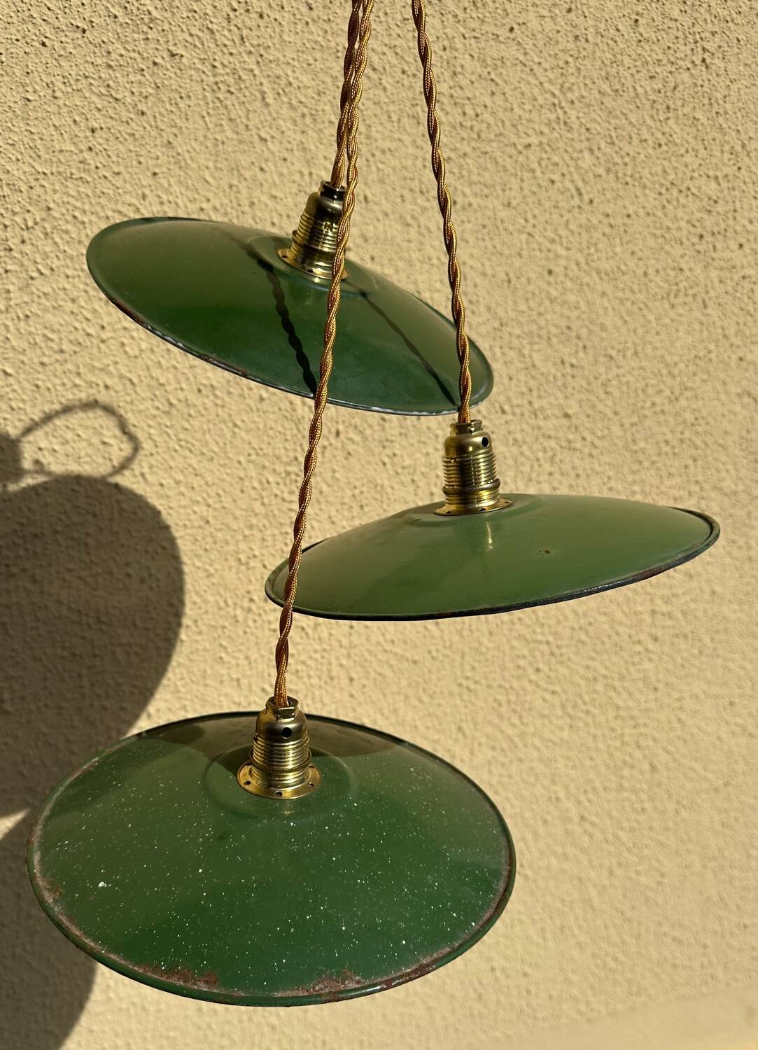 Trio of vintage green enamelled sheet metal lampshade pendants