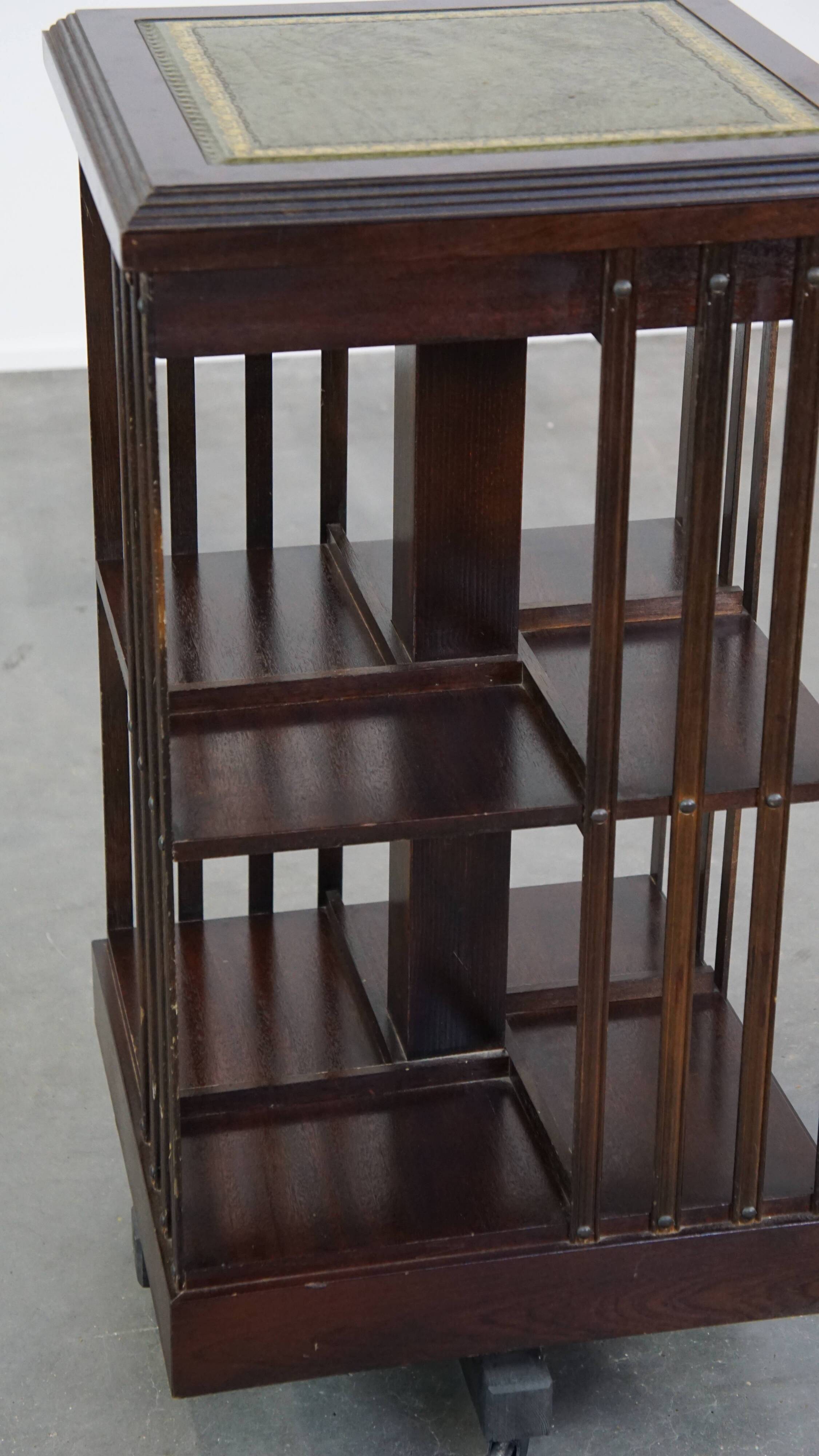 Wooden bookstand with green leather surface and on wheels in English style