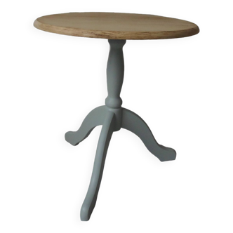 Pedestal table with verdigris tripod base, wooden top.
