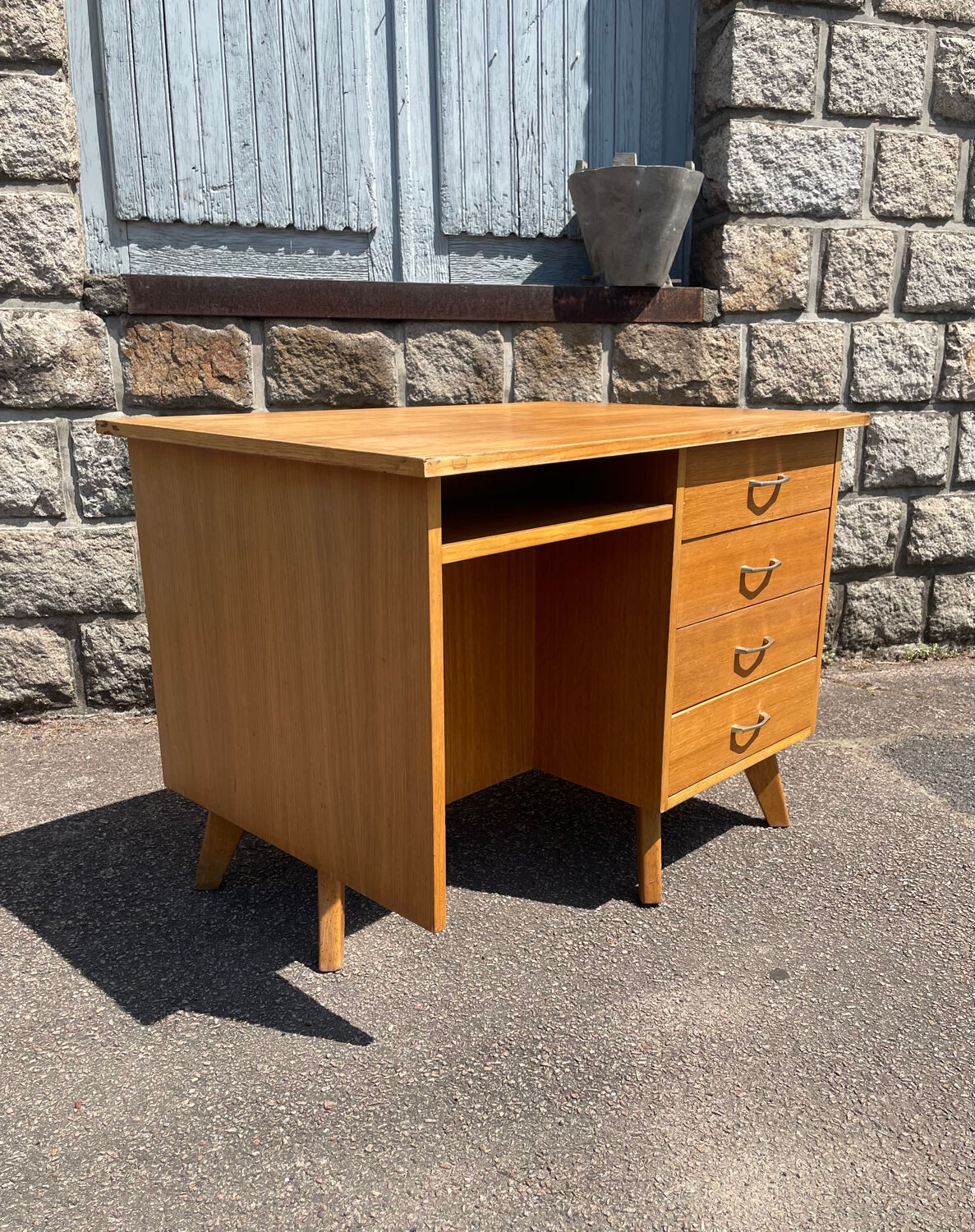 Double-sided desk with compass legs.