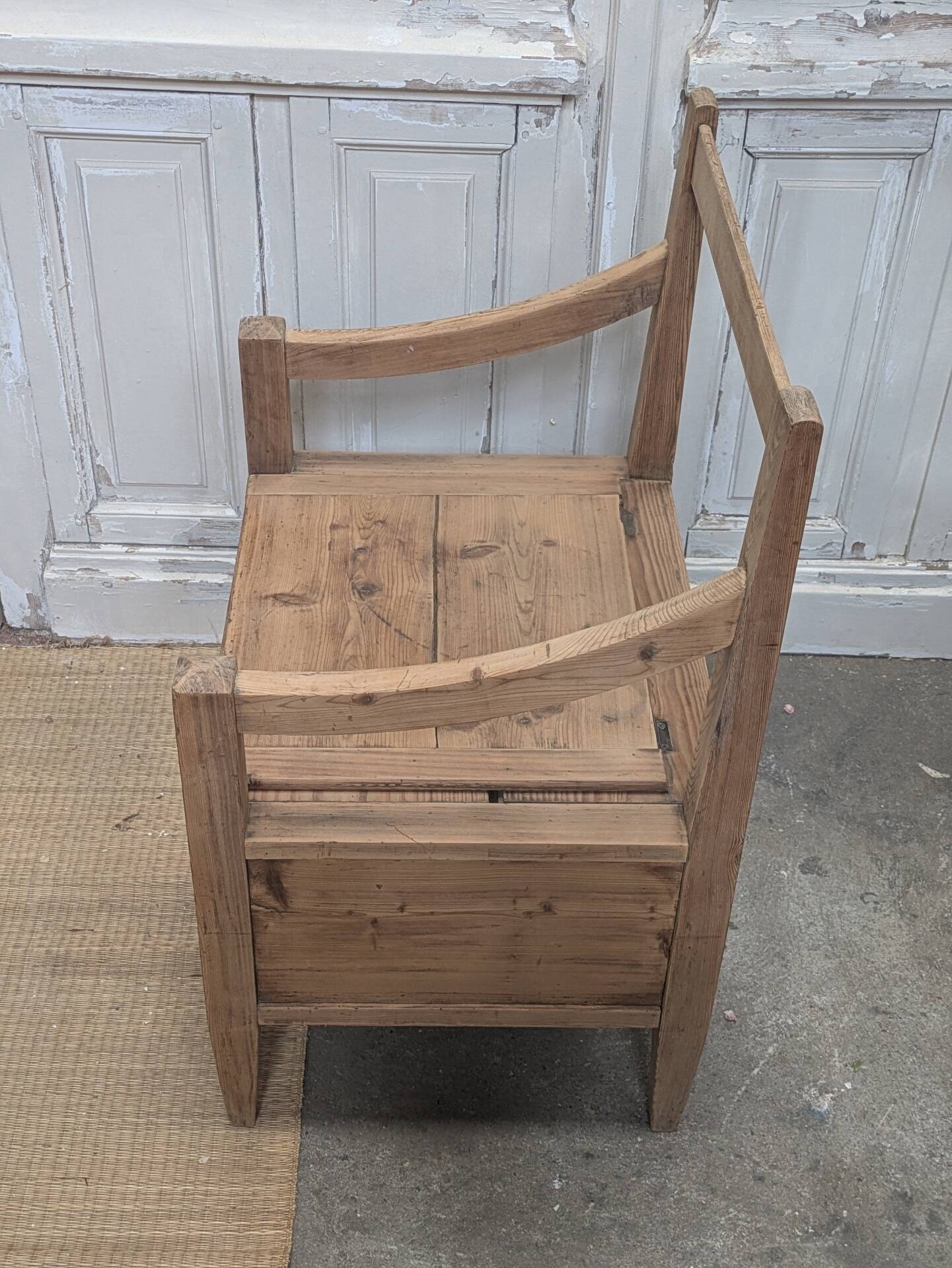 Antique armchair in raw wood