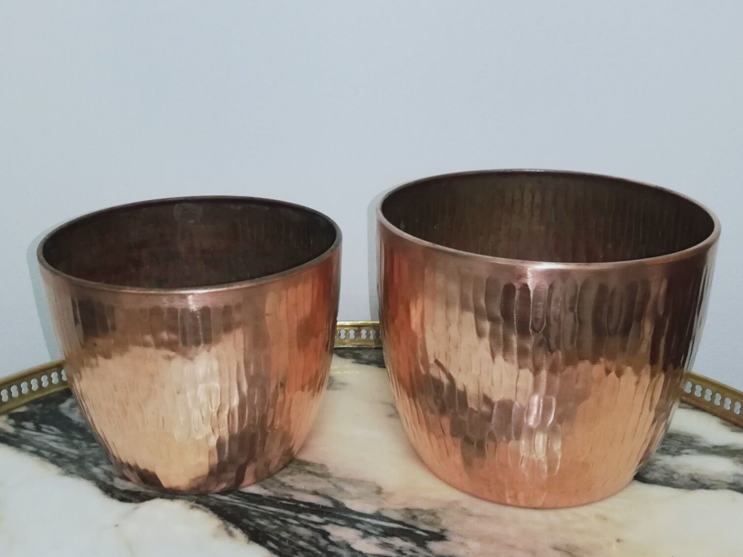 Duo of hammered copper pot covers