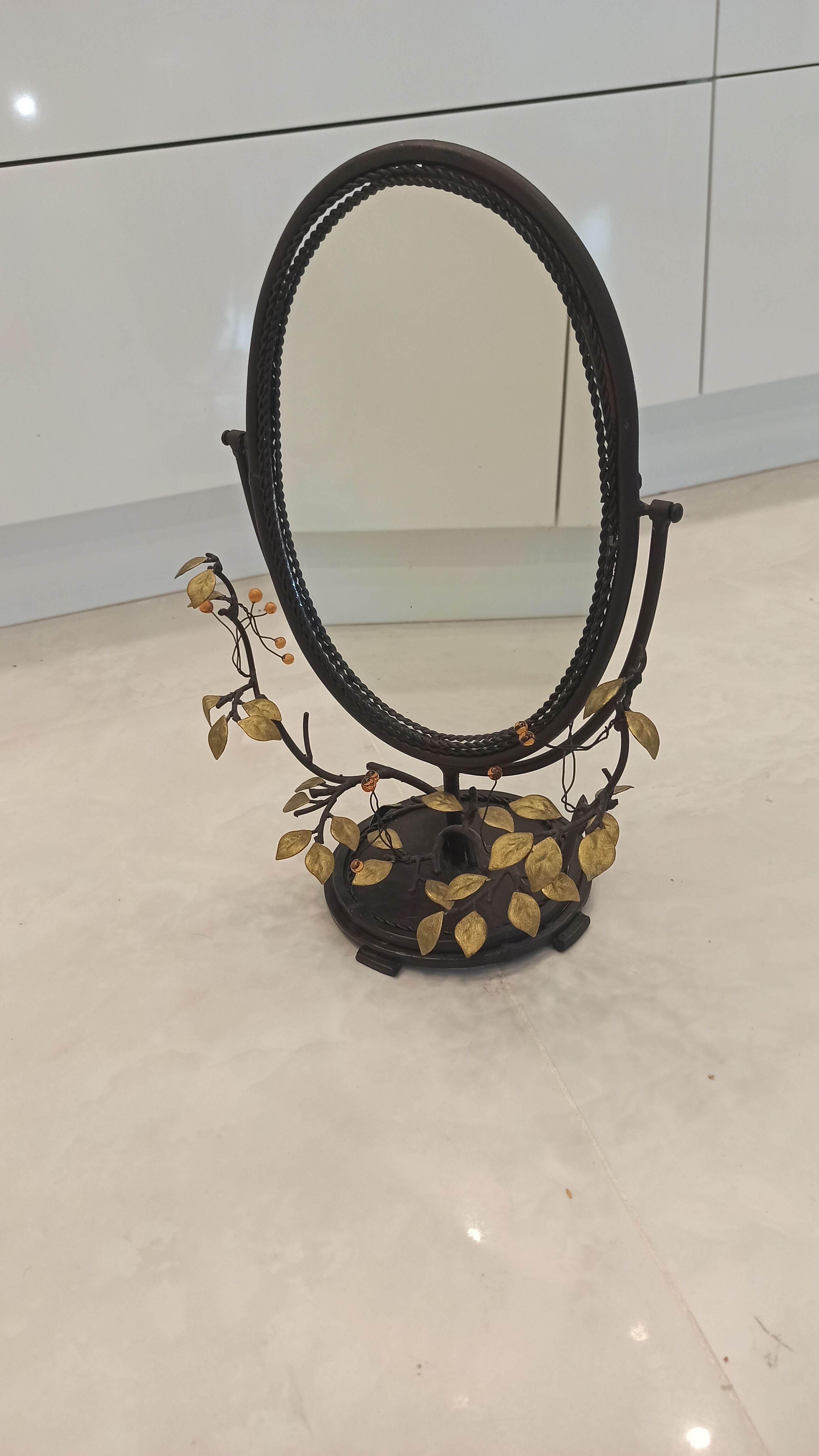 Table mirror, tilting psyche in patinated bronze decorated with leaves and fruits