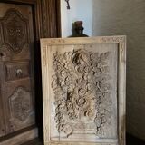 wooden painting with carved floral motif - note a restoration on the left side at the bottom.