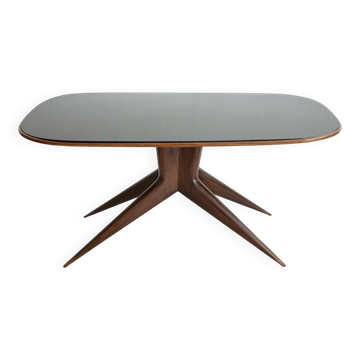 Dining table with a wooden frame and tinted glass top.
