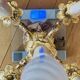 Pair of gilt bronze chandeliers, marble bases.