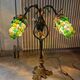 Bronze table lamp and Murano glass grape clusters.