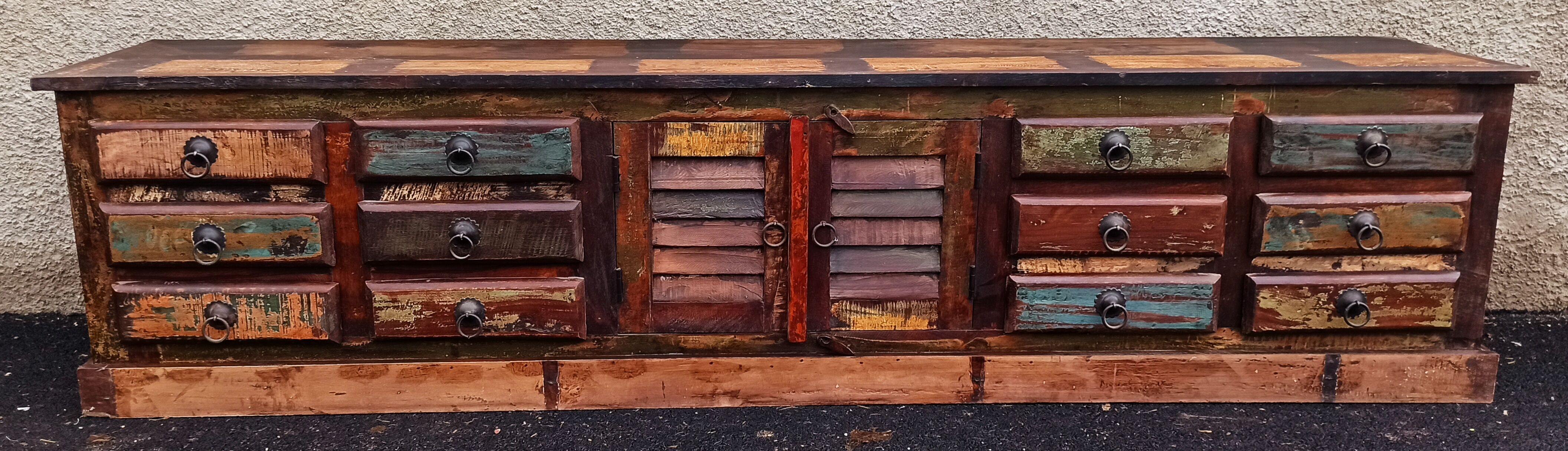 Furniture low in colorful wood. 12 drawers and 1 door