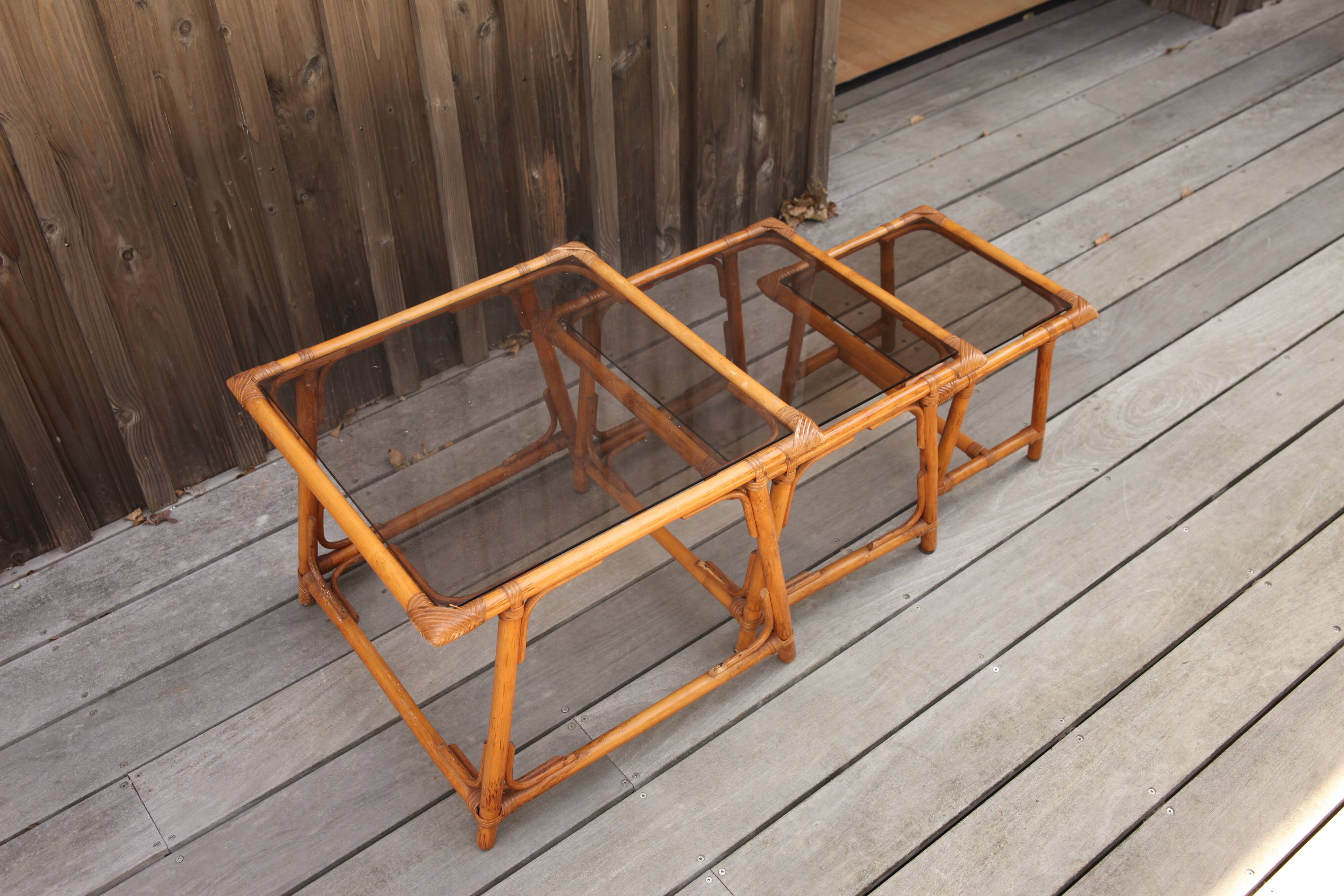 Nesting tables in rattan and glass