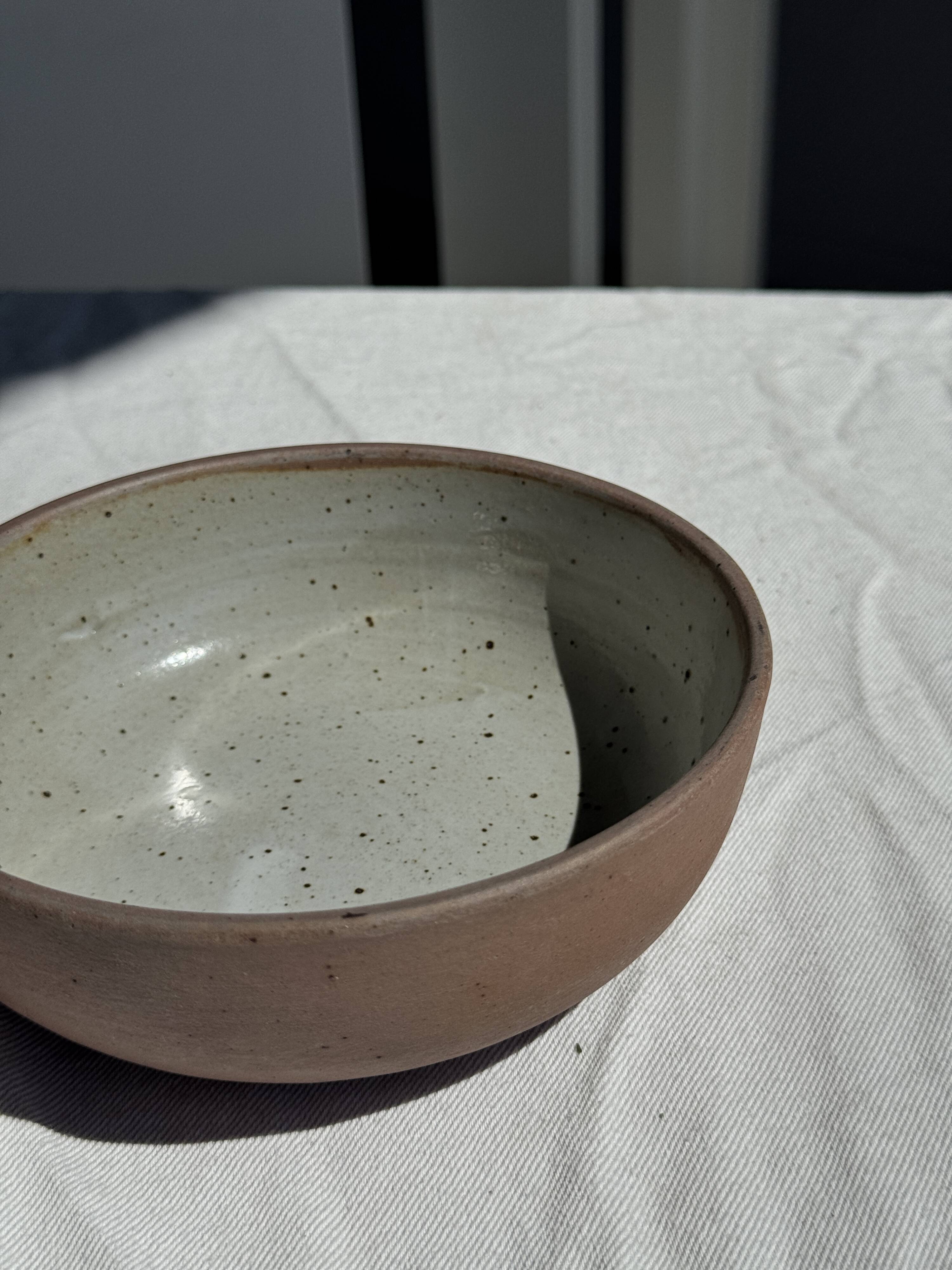 A speckled grey interior bowl with a matte brown exterior H5 D15